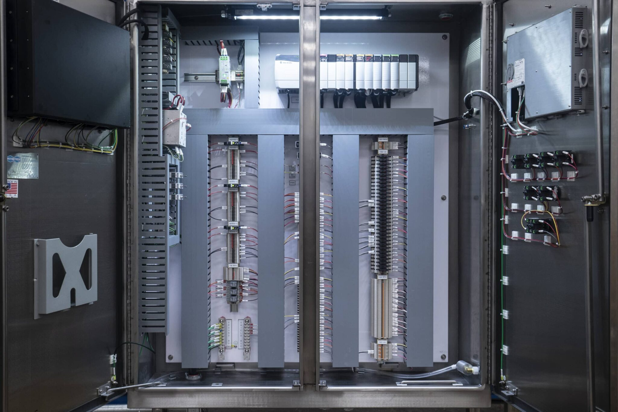Interior of a large control cabinet with terminal blocks and wiring