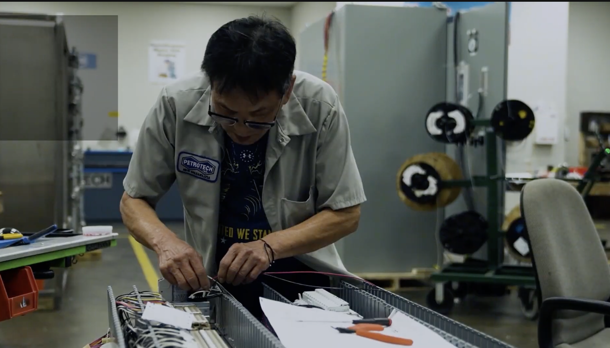Technician wiring a control panel in the fabrication shop