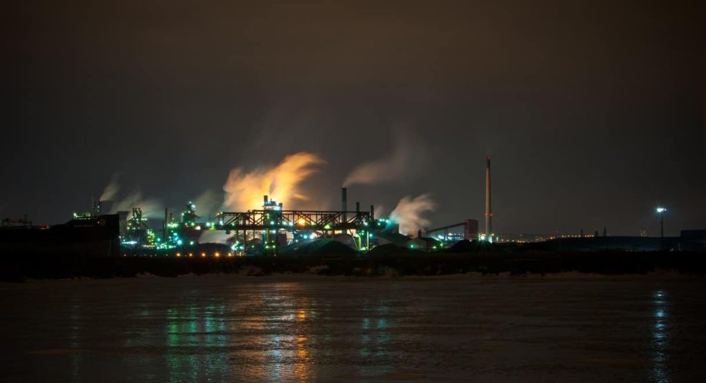 An oil refinery at night, which most likely has a gas turbine power plant layout